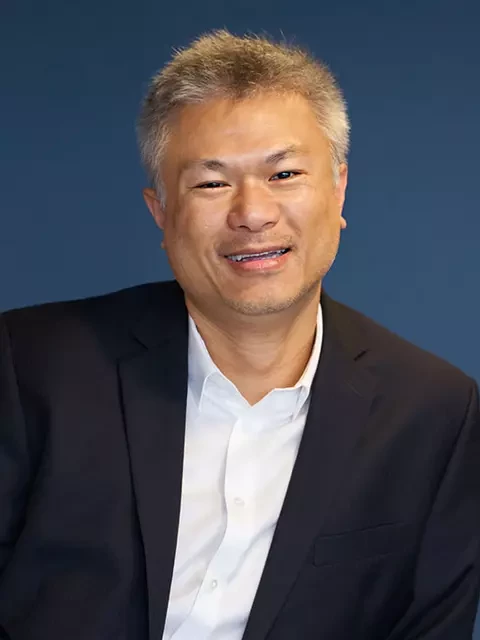 Kevin RisonChu dressed in a black suit and white shirt who's a AWS Consulting Partner, Co-Founder and CTO of Stratus10